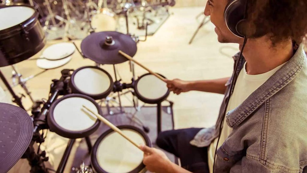 Drumsticks pointing in the same direction but hitting different drums